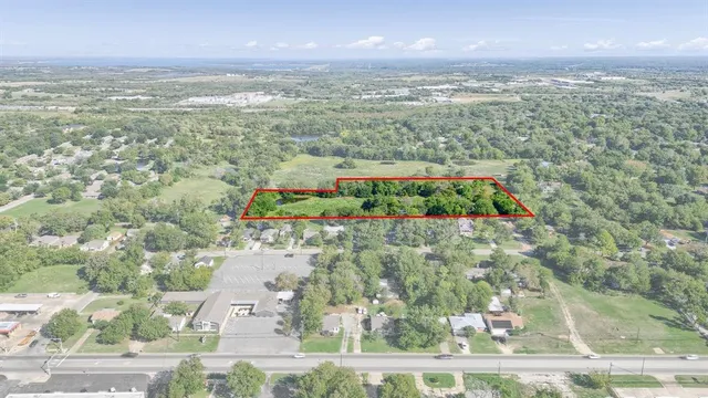 a view of a green field with lots of bushes