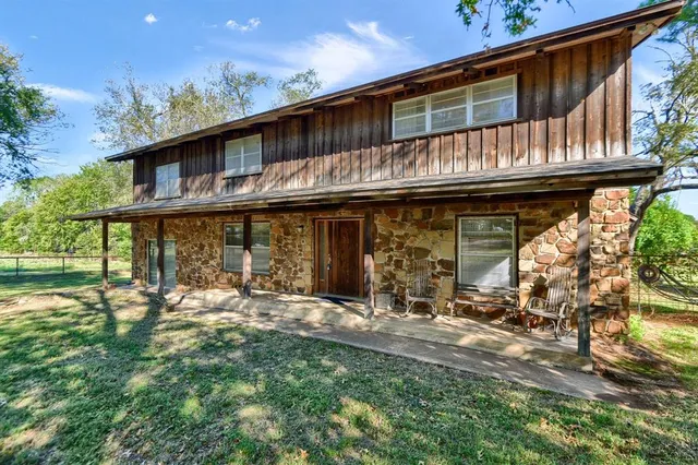 a backyard of a house with yard and outdoor seating