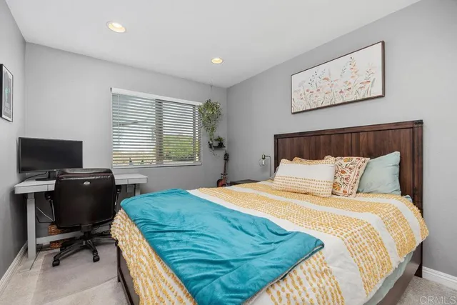 a bedroom with a bed and a view of bedroom