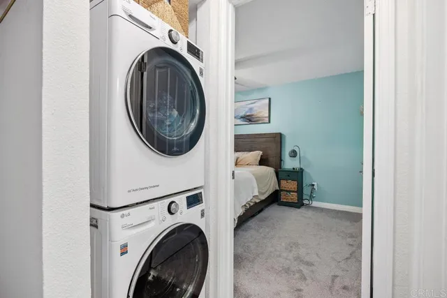 a bedroom with a bed a dresser and potted plants