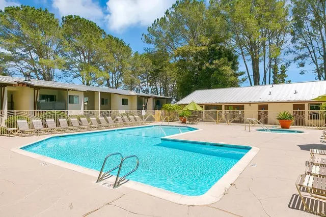a view of a dining room with furniture and a window