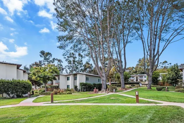 a view of a chairs and table in the backyard