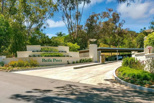 a front view of a house with a tree