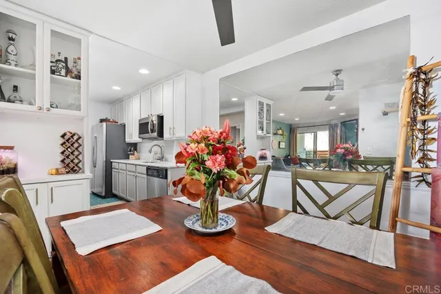 a view of a dining room with furniture and a kitchen