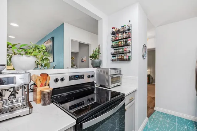 a kitchen with stainless steel appliances granite countertop a sink dishwasher a microwave oven and a dining table with wooden floor