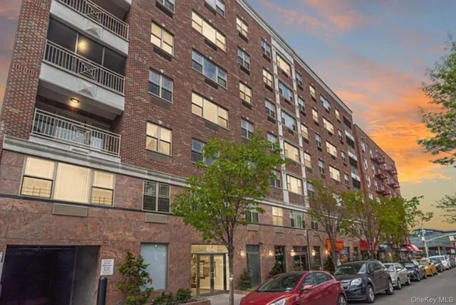 a couple of cars parked in front of brick building
