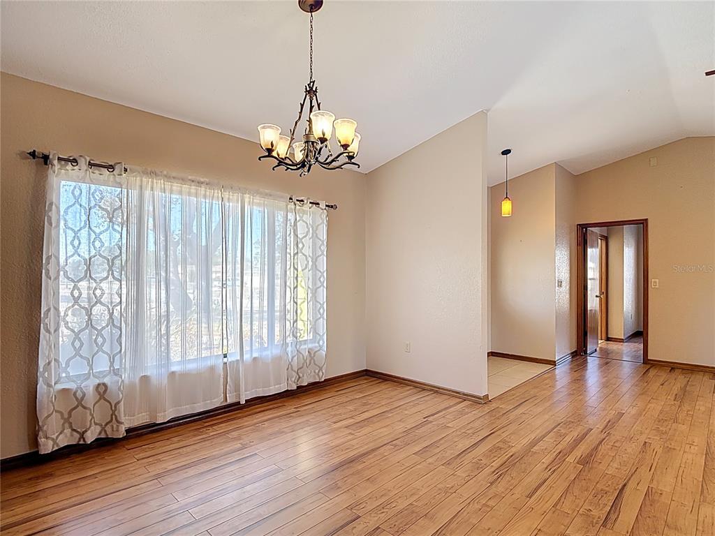 5066 Woodbine Street Spring Hill, FL 34608 - Photo 13 of 59 a view of an empty room with wooden floor and a window