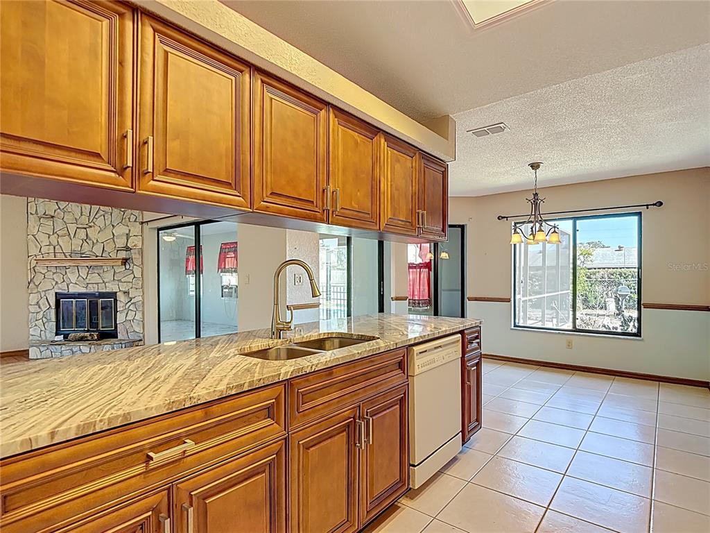 5066 Woodbine Street Spring Hill, FL 34608 - Photo 16 of 59 a kitchen with stainless steel appliances granite countertop a sink and cabinets