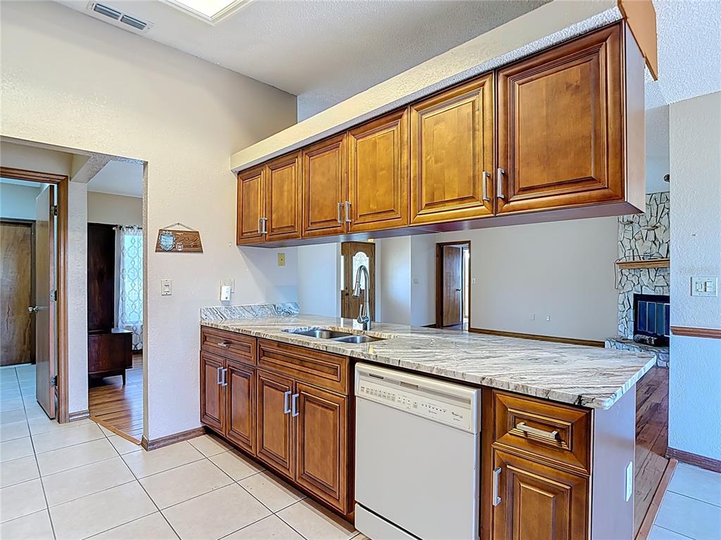 5066 Woodbine Street Spring Hill, FL 34608 - Photo 17 of 59 a kitchen with stainless steel appliances granite countertop a stove and a sink