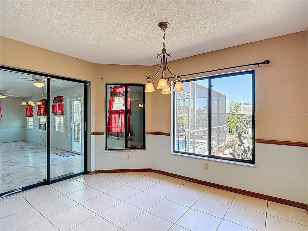 5066 Woodbine Street Spring Hill, FL 34608 - Photo 21 of 59 a view of an entryway with a chandelier