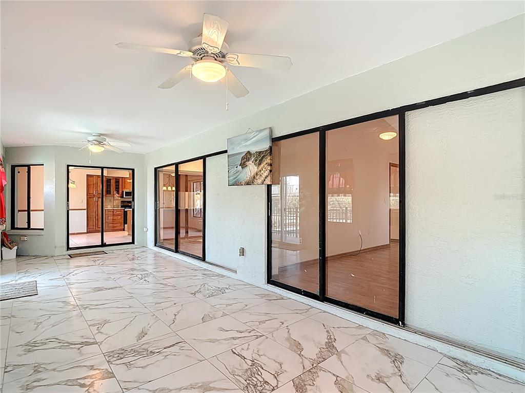 5066 Woodbine Street Spring Hill, FL 34608 - Photo 25 of 59 a view of an empty room with window and chandelier fan