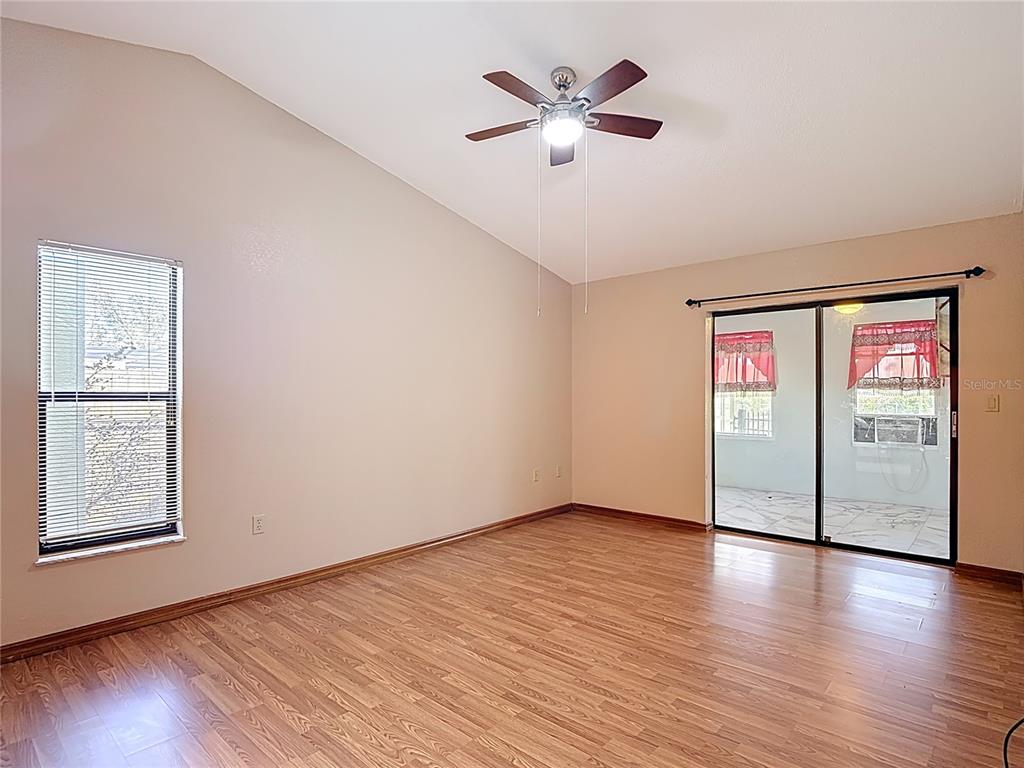 5066 Woodbine Street Spring Hill, FL 34608 - Photo 30 of 59 a view of an empty room with window and wooden floor