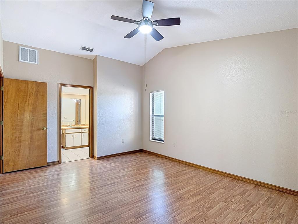 5066 Woodbine Street Spring Hill, FL 34608 - Photo 31 of 59 a view of an empty room with window and wooden floor