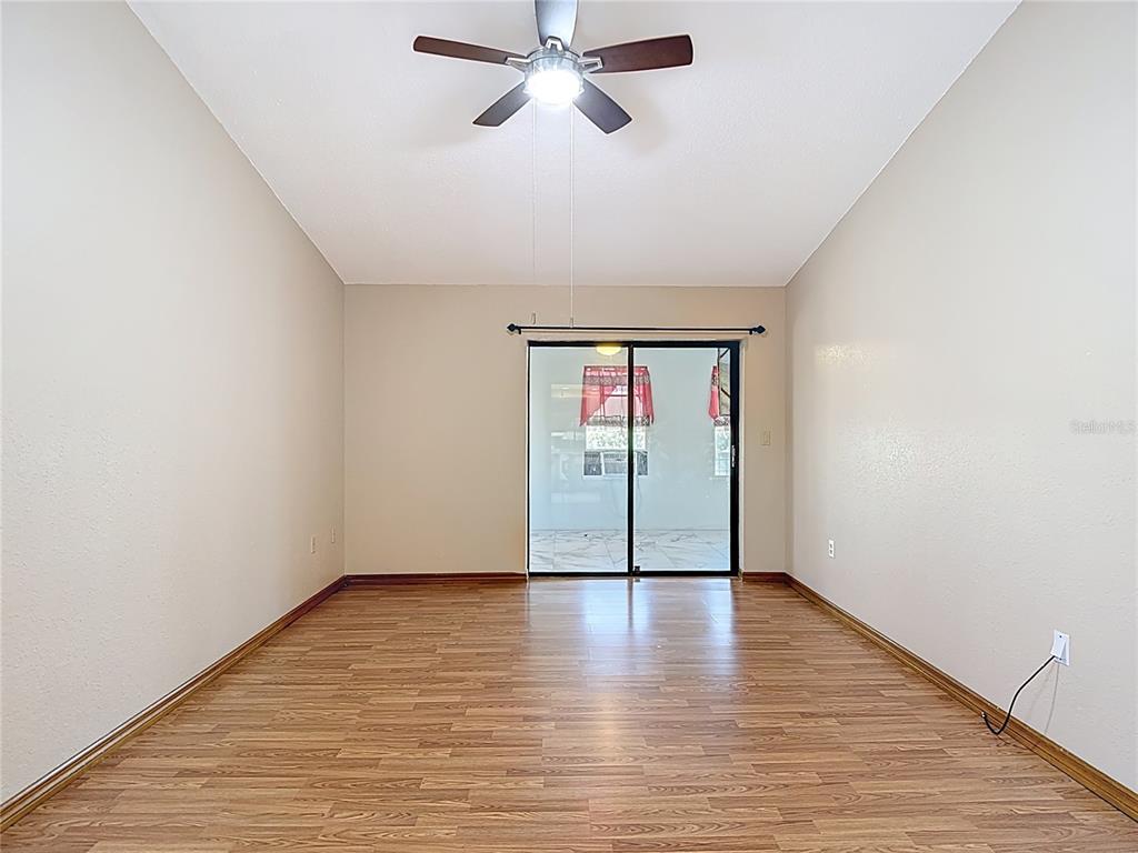 5066 Woodbine Street Spring Hill, FL 34608 - Photo 34 of 59 a view of an empty room with wooden floor and a window