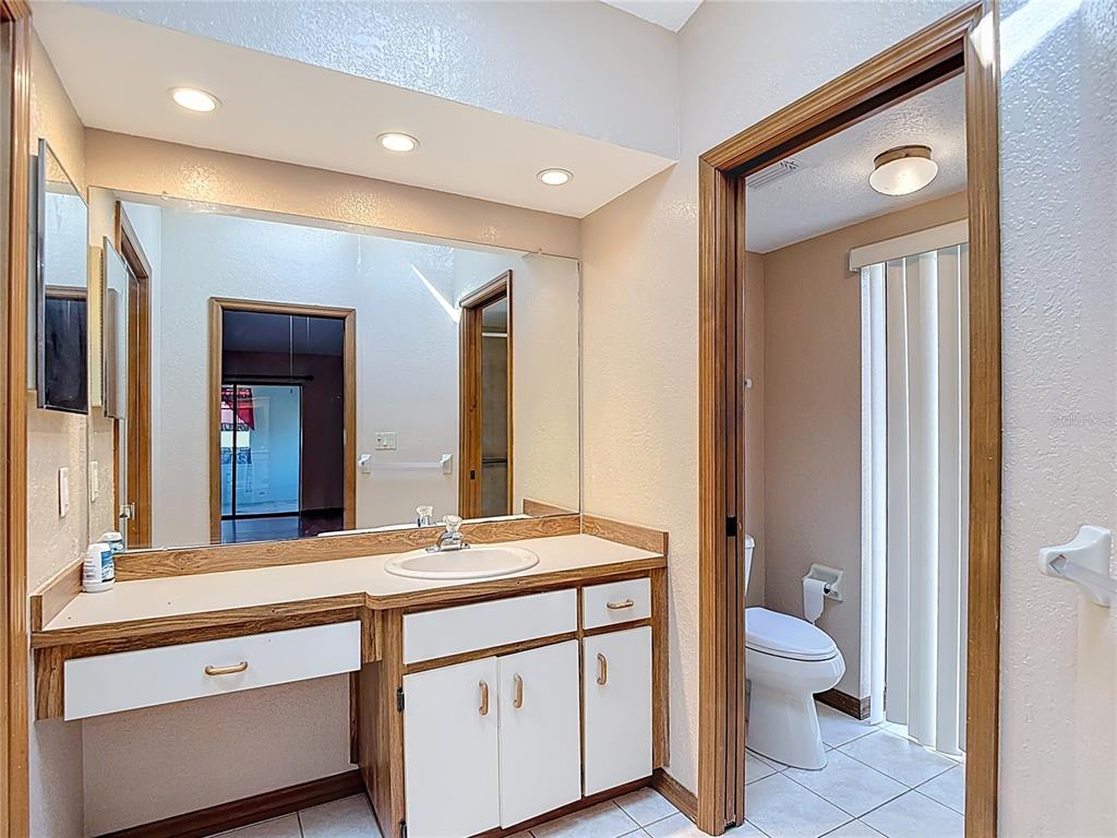 5066 Woodbine Street Spring Hill, FL 34608 - Photo 36 of 59 a bathroom with a double vanity sink toilet and shower
