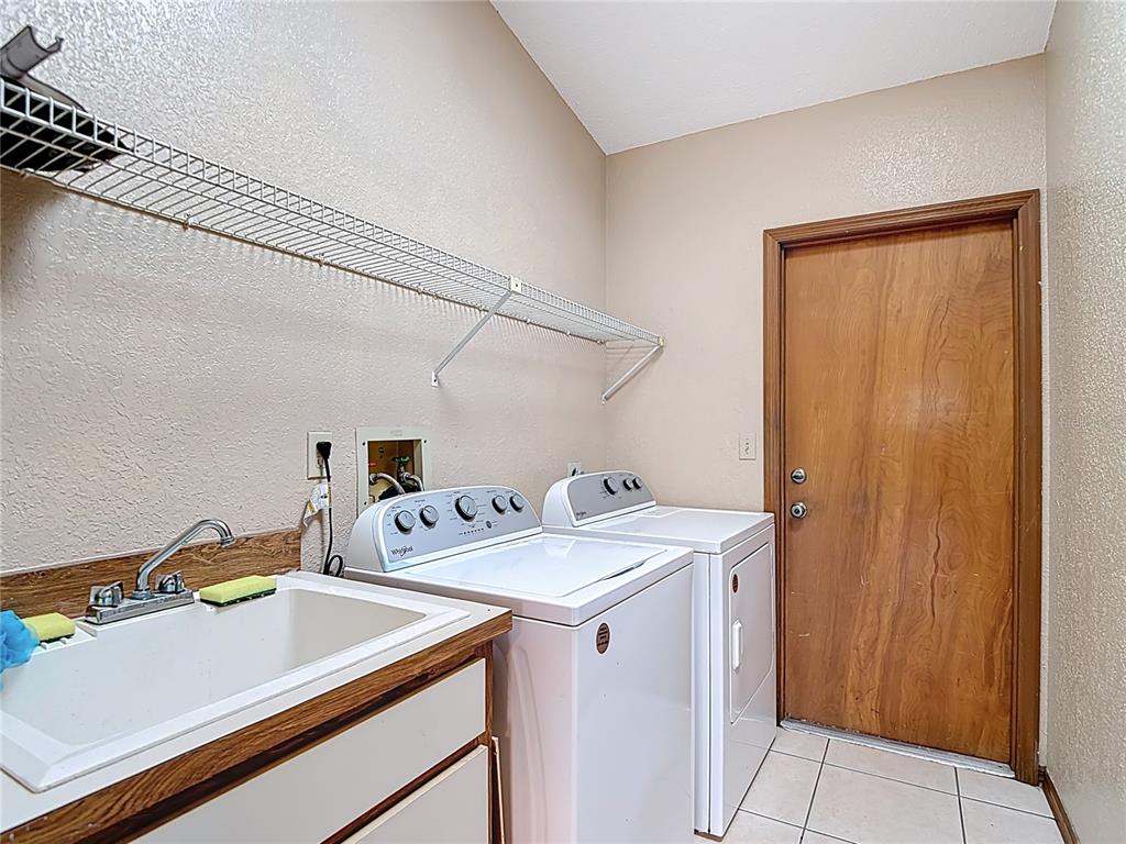 5066 Woodbine Street Spring Hill, FL 34608 - Photo 40 of 59 a utility room with dryer and washer