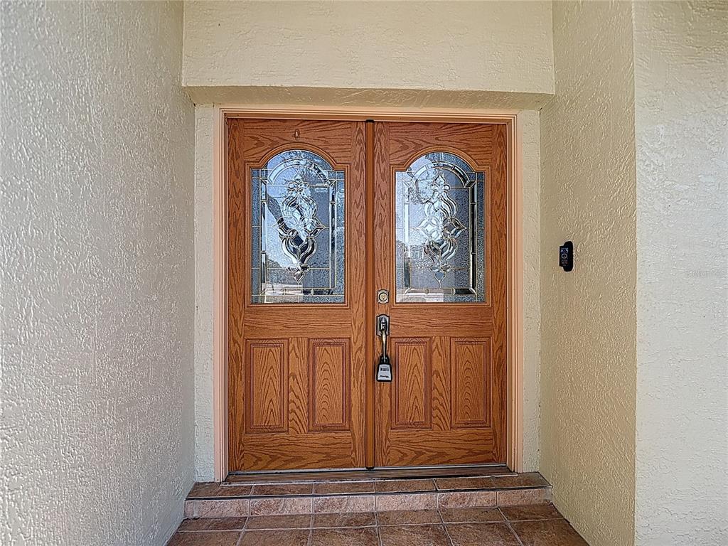 5066 Woodbine Street Spring Hill, FL 34608 - Photo 4 of 59 view of front door with wooden door