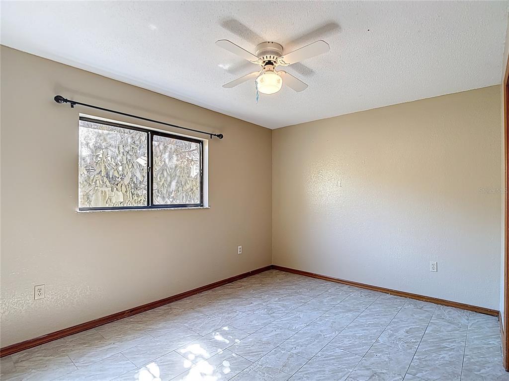 5066 Woodbine Street Spring Hill, FL 34608 - Photo 42 of 59 an empty room with windows and fan