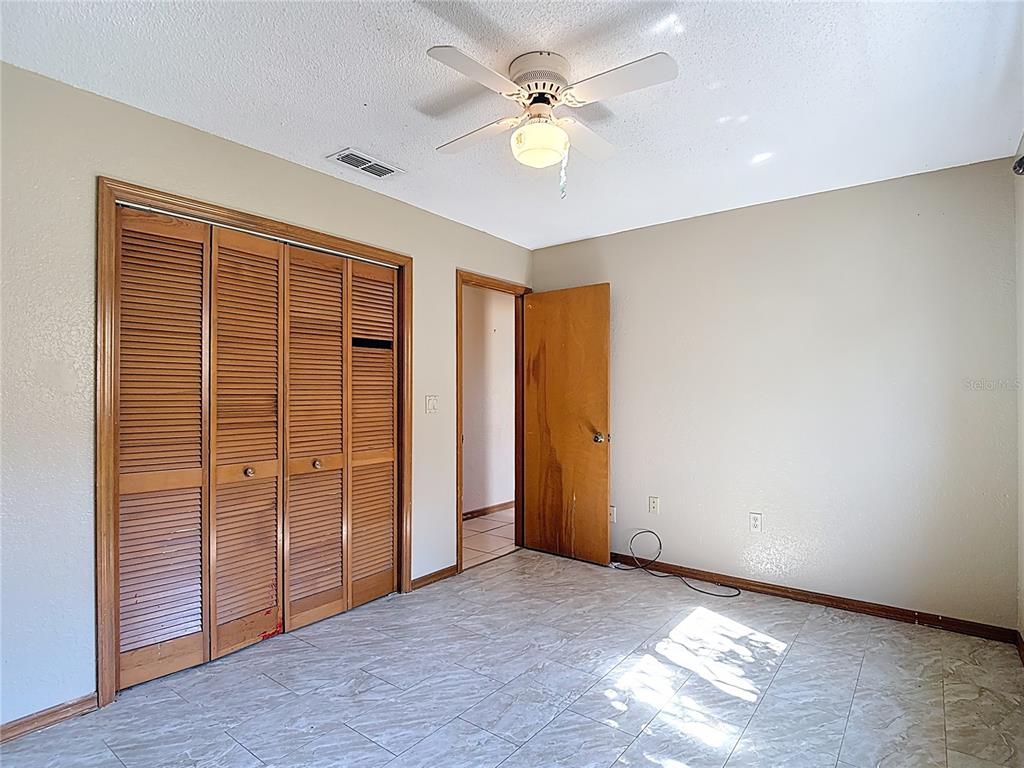 5066 Woodbine Street Spring Hill, FL 34608 - Photo 44 of 59 an empty room with closet and windows