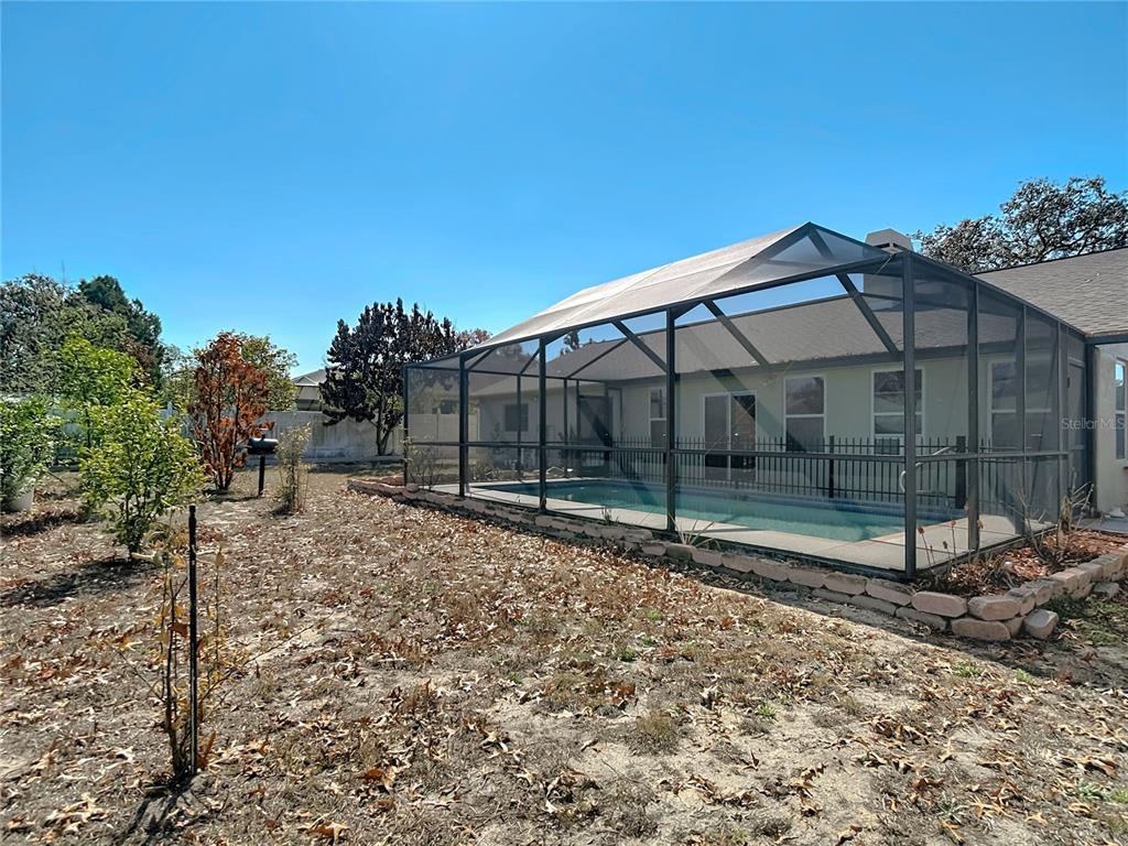 5066 Woodbine Street Spring Hill, FL 34608 - Photo 53 of 59 a backyard of a house with lots of green space