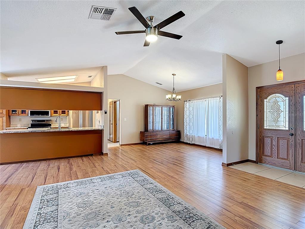 5066 Woodbine Street Spring Hill, FL 34608 - Photo 7 of 59 a view of an empty room with window and wooden floor