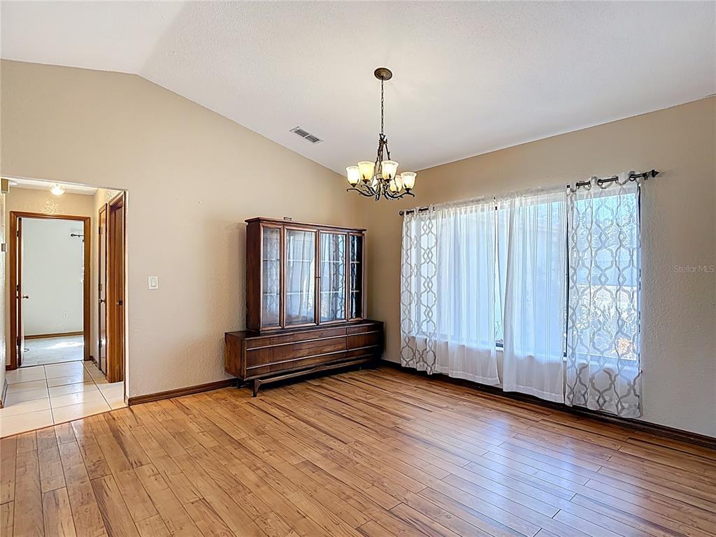 5066 Woodbine Street Spring Hill, FL 34608 - Photo 10 of 59 a view of an empty room with wooden floor and a window