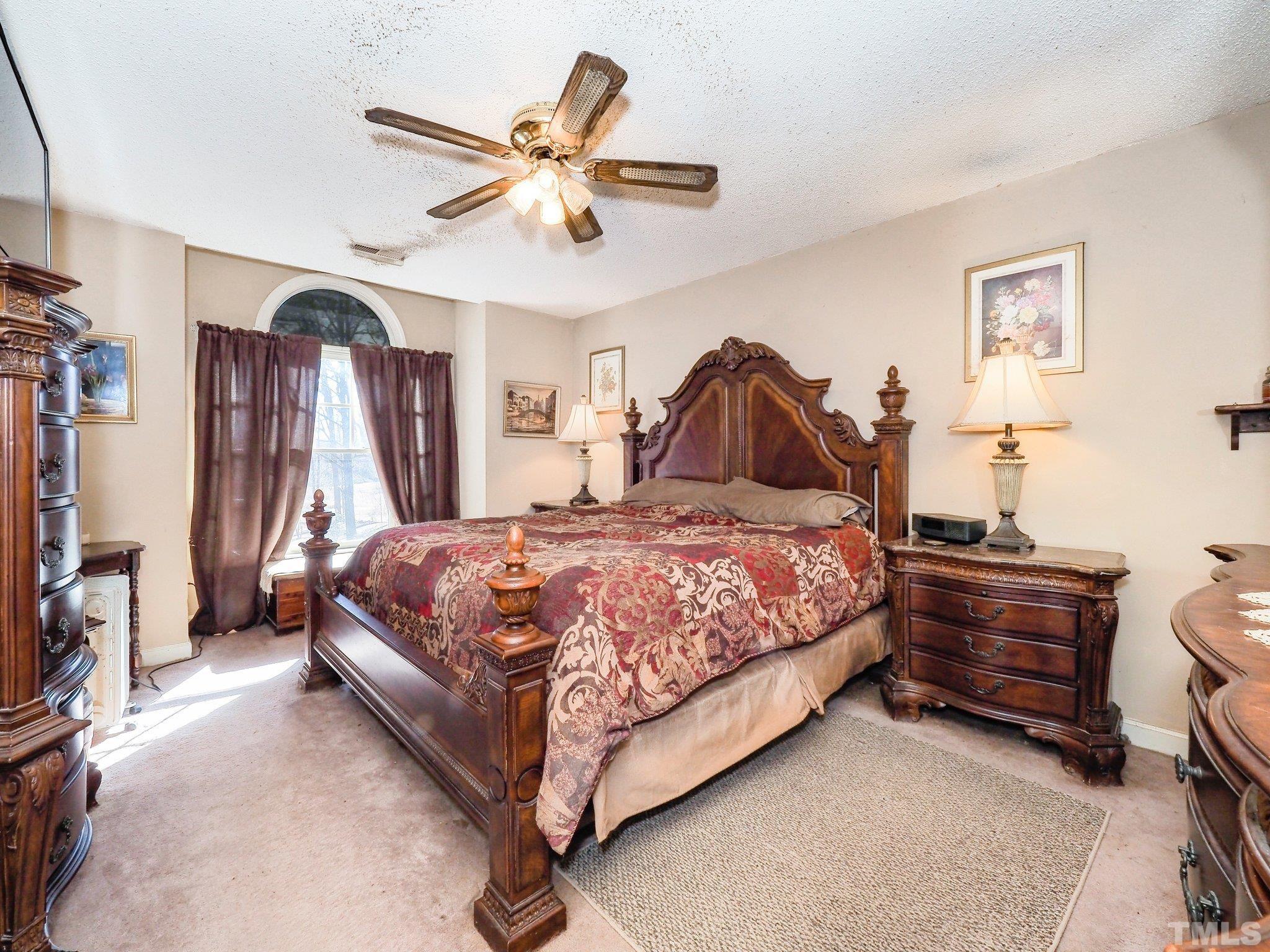 6030 Forestville Road Raleigh, NC 27604 - Photo 11 of 15 a bedroom with a bed chandelier and a window