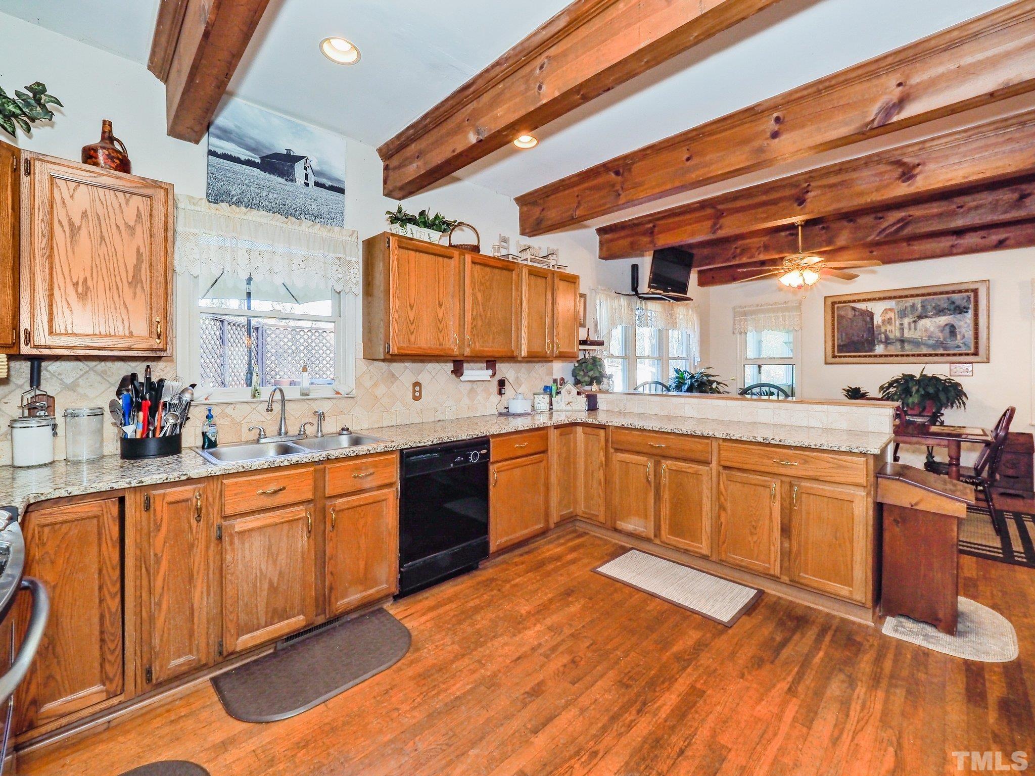 6030 Forestville Road Raleigh, NC 27604 - Photo 5 of 15 a large kitchen with stainless steel appliances granite countertop wooden cabinets a sink and dishwasher
