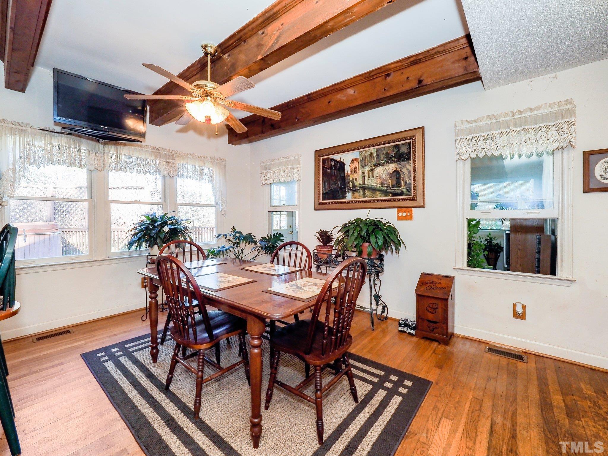 6030 Forestville Road Raleigh, NC 27604 - Photo 6 of 15 a view of a dining room with furniture window and wooden floor