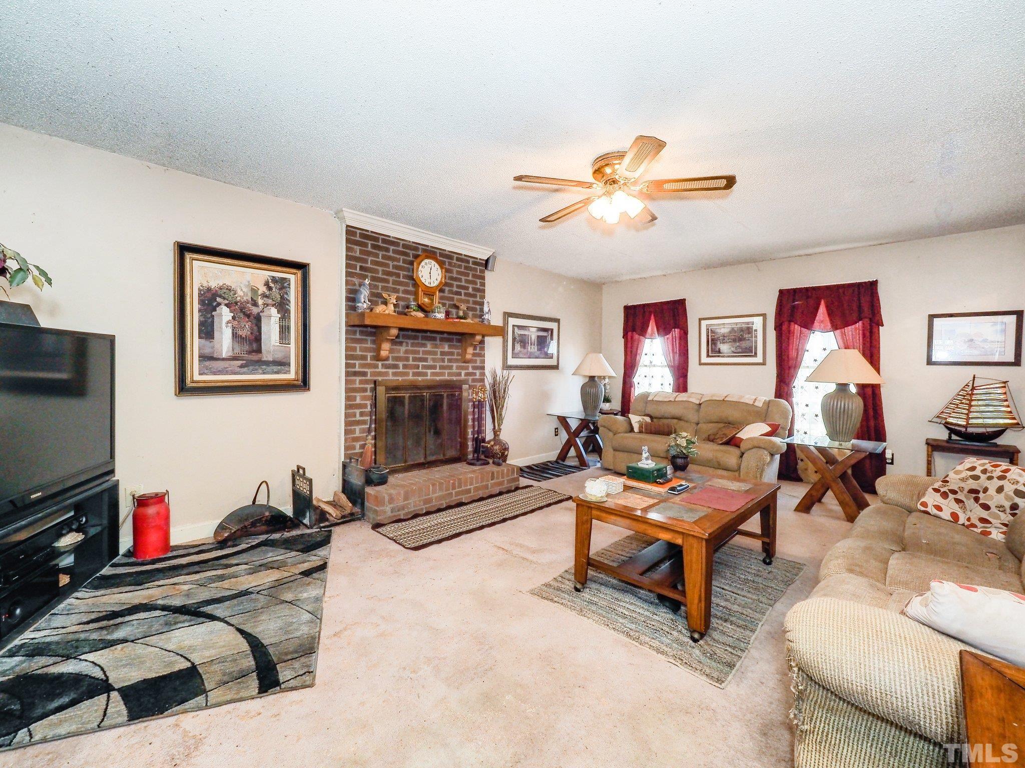 6030 Forestville Road Raleigh, NC 27604 - Photo 7 of 15 a living room with furniture and a flat screen tv