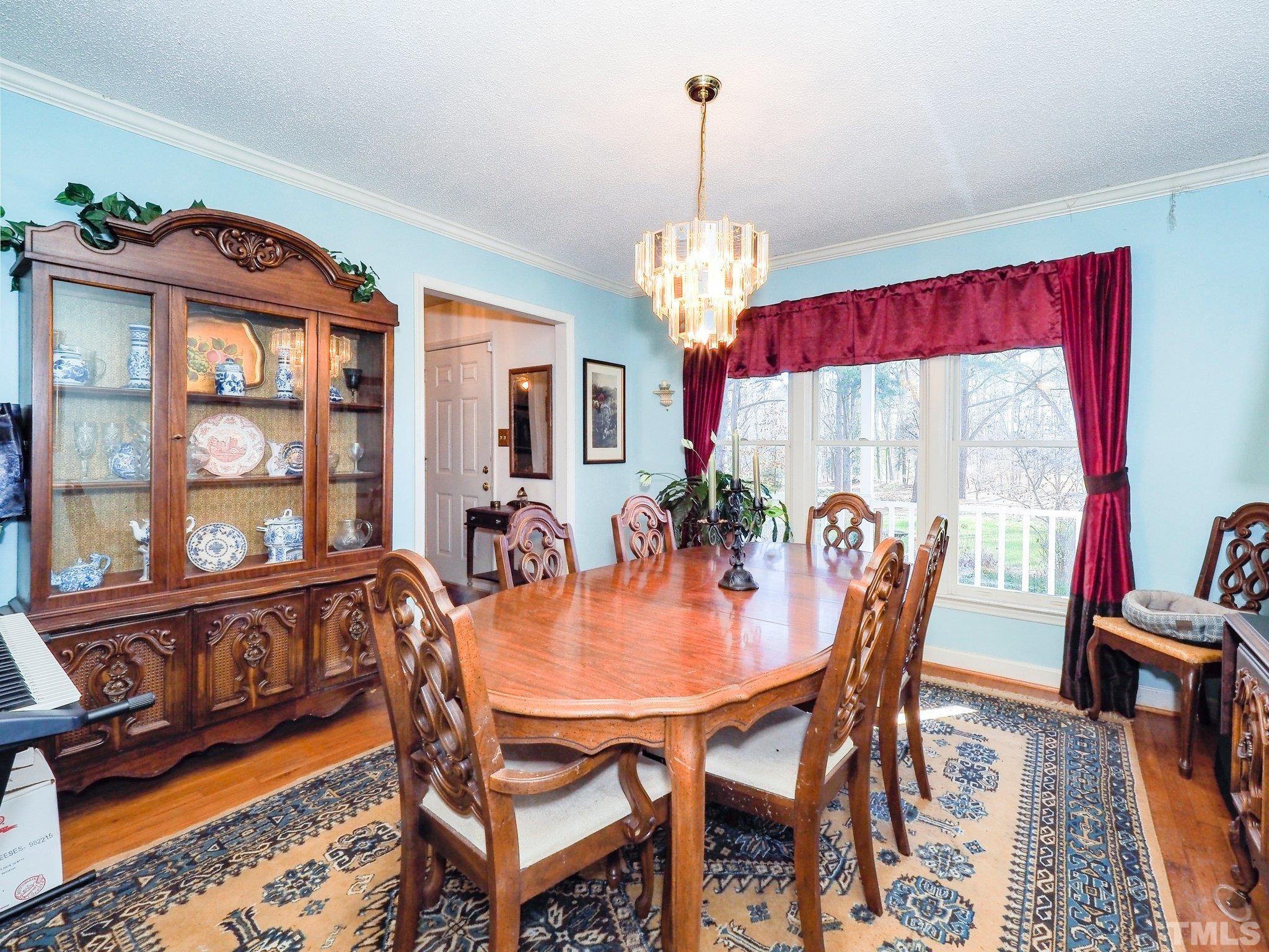 6030 Forestville Road Raleigh, NC 27604 - Photo 8 of 15 a view of a dining room with furniture wooden floor and a chandelier