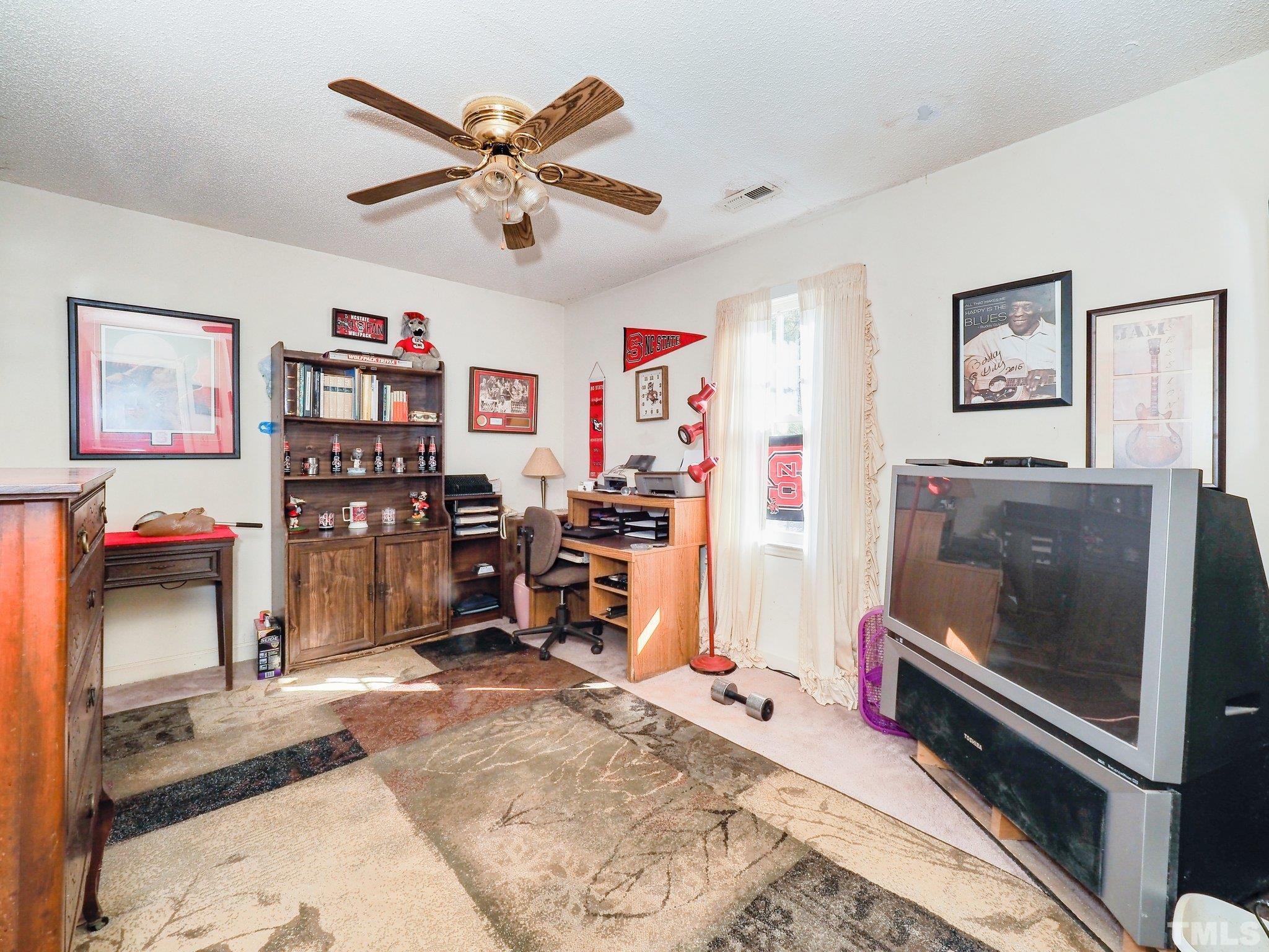 6030 Forestville Road Raleigh, NC 27604 - Photo 10 of 15 a living room with furniture and a flat screen tv