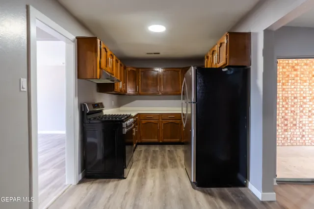 a kitchen with a refrigerator and a stove