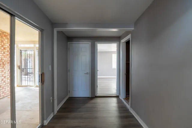 a view of hallway with wooden floor
