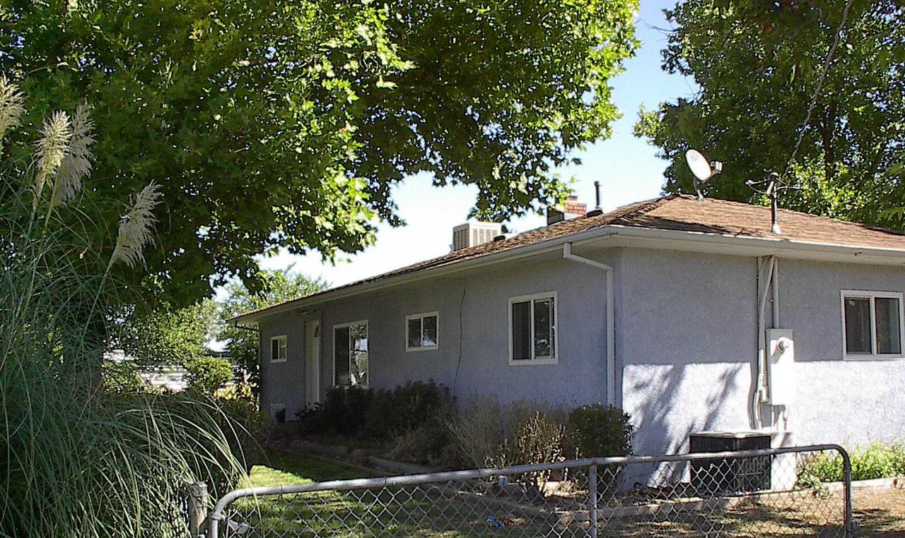 21690 Lone Tree Road Anderson, CA 96007 - Photo 1 of 2 a front view of a house with yard and tree s