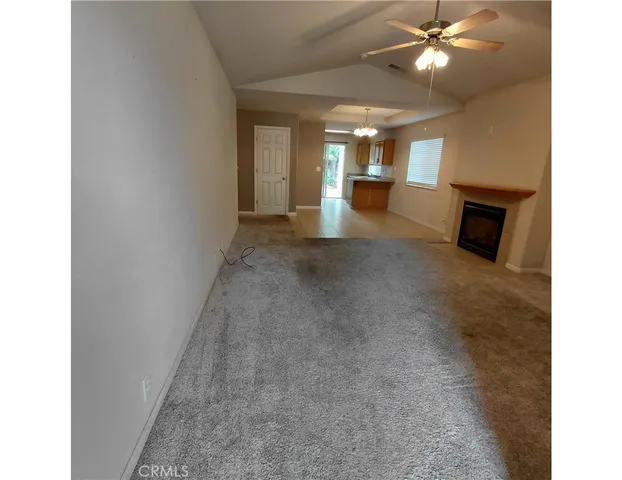 a view of a livingroom with a ceiling fan and window