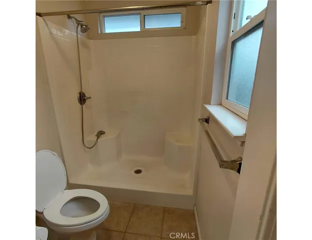a bathroom with a toilet and a shower