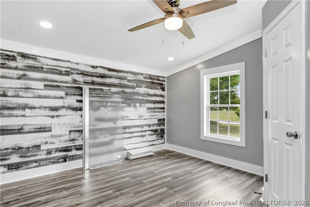 7225 Deep Branch Road Pembroke, NC 28372 - Photo 13 of 27 a view of an empty room with a window and wooden floor
