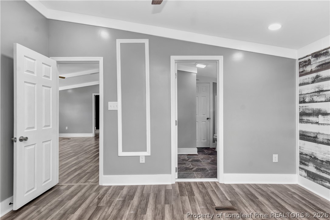 7225 Deep Branch Road Pembroke, NC 28372 - Photo 14 of 27 a view of a room with wooden floor and a bathroom