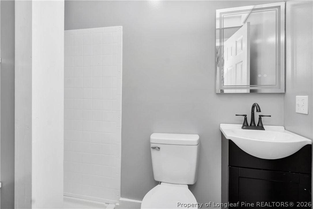 7225 Deep Branch Road Pembroke, NC 28372 - Photo 21 of 27 a bathroom with a toilet sink and mirror