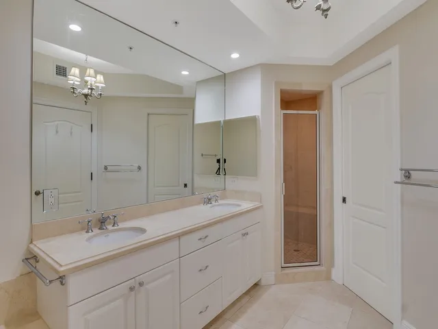 a bathroom with a sink double vanity and a mirror