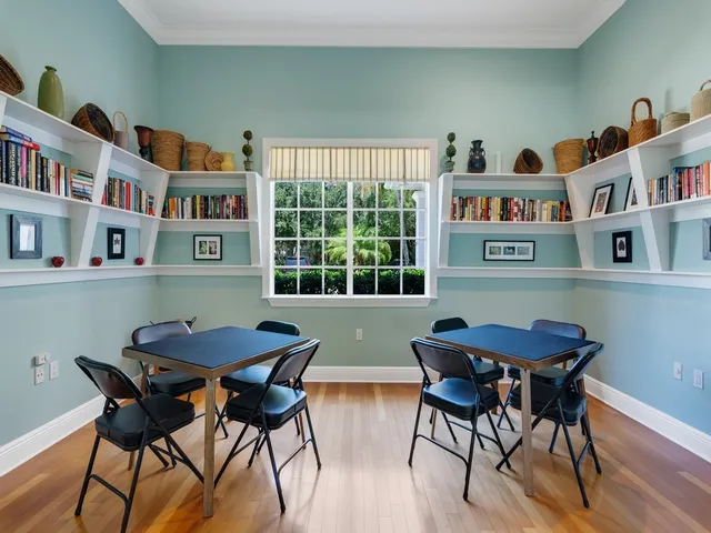a view of a dining room with furniture and a book shelf
