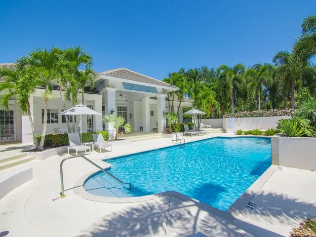 a view of a house with swimming pool and sitting area