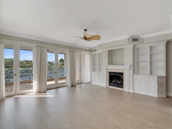 a view of an empty room with a fireplace and a window