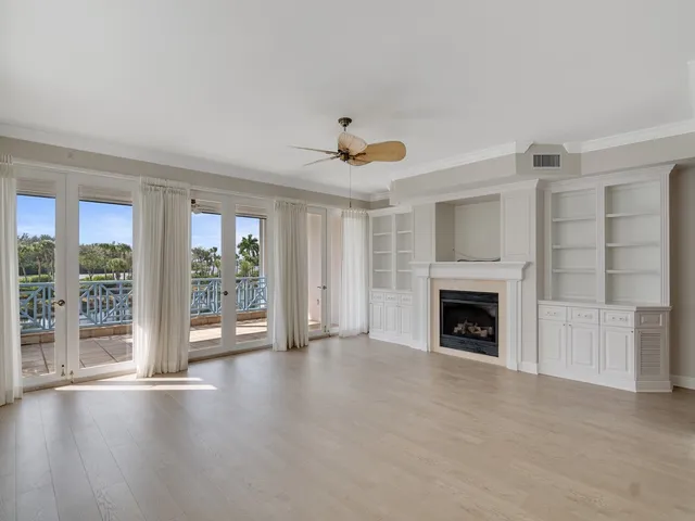 a view of an empty room with a fireplace and a window