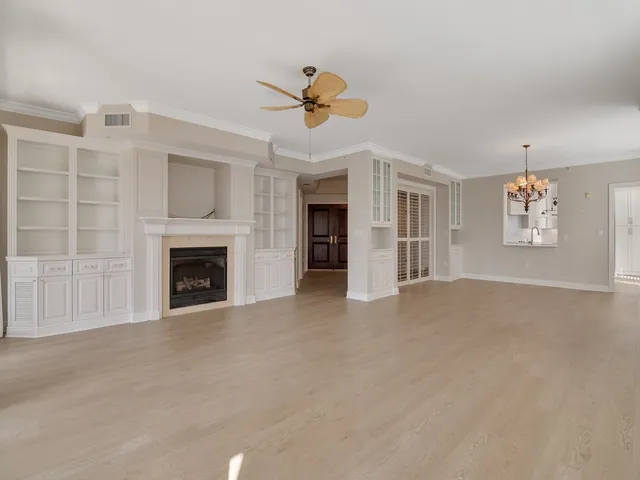 a view of empty room with fireplace and fan