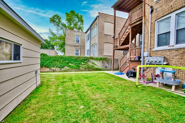 a view of backyard with a garden and deck