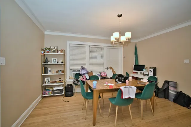 a view of a dining room with furniture and chandelier