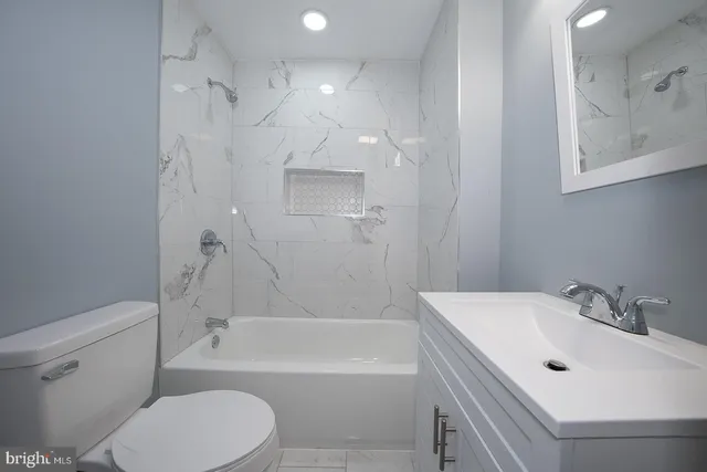 a bathroom with a sink toilet and bathtub
