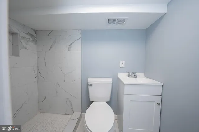a bathroom with a toilet and a sink